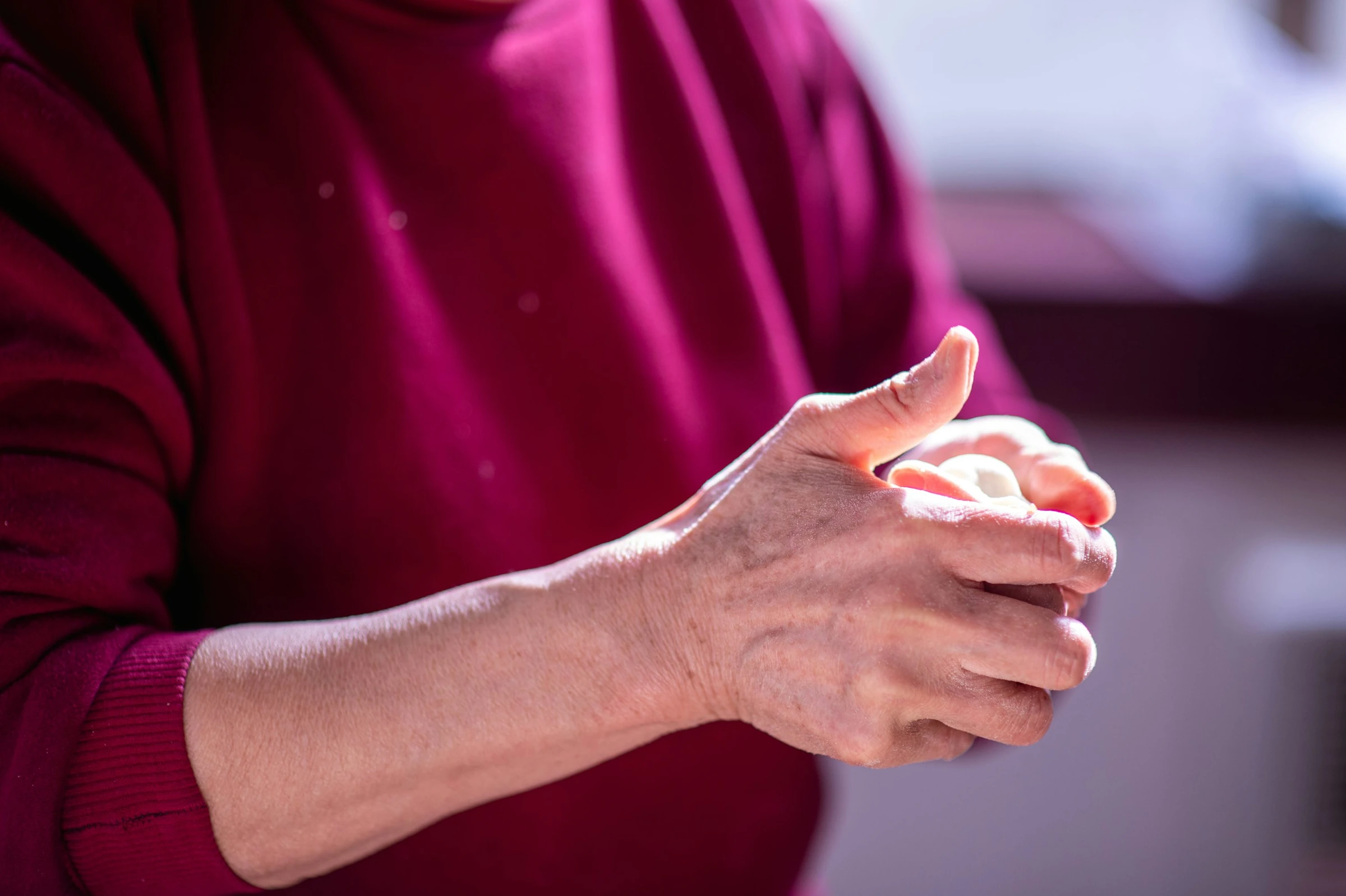 Adult supporting a painful hand and wrist