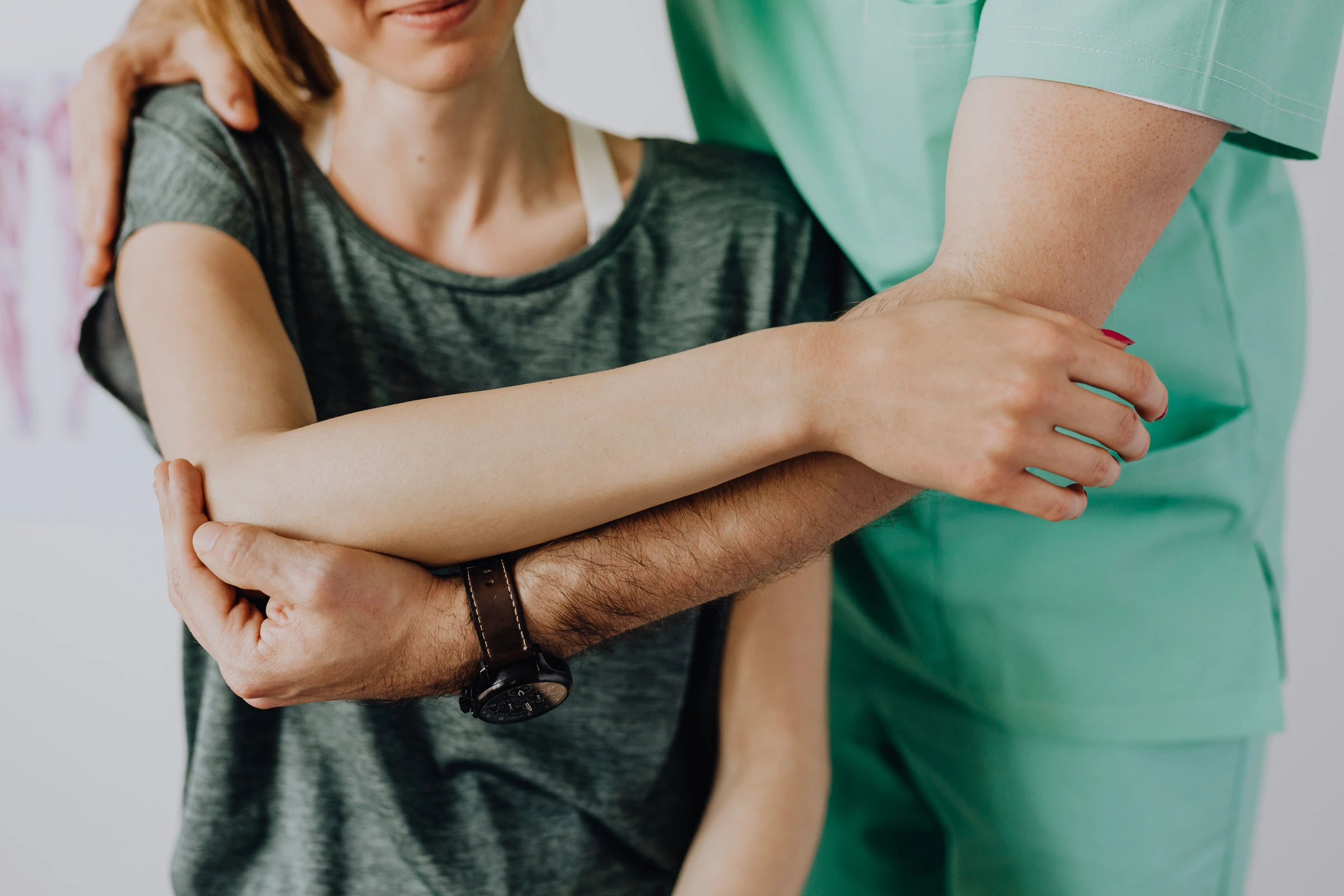 Clinician assessing shoulder movement